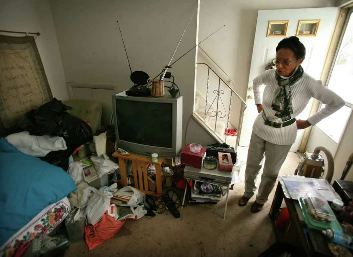 Carleen McDowell looks at her cluttered living room in her apartment at 95A Yaremich Drive in Bridgeport. McDowell, 74, hopes to donate most of her possessions to charity so that she can most into senior housing in Pennsylvania.