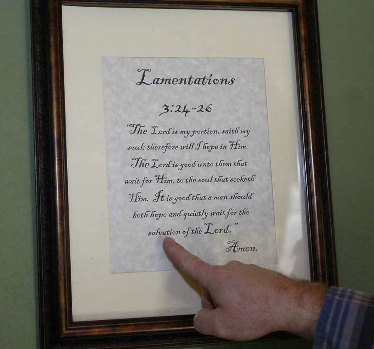 In Clayt Kinard's home, above the chair where he has studied the Bible for more than five years, is a framed favorite verse from the Bible. Dave Ryan/The Enterprise