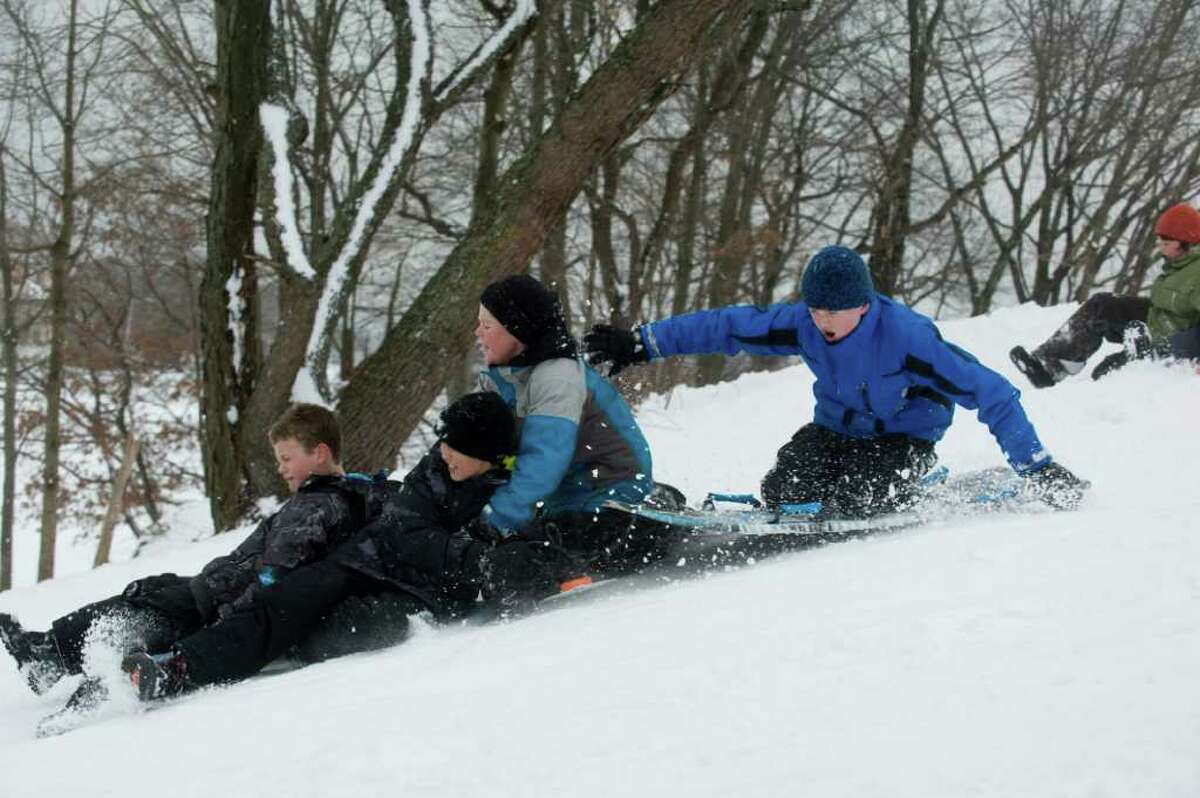 from left, Harrison Burns, Jack Ende, Keegan Bowes and William Marment find Cummings Park offers solid sledding after the storm in Stamford, Conn., Wednesday, January 12, 2011., January 12, 2011.