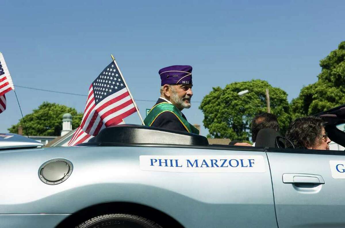 Norwalk's 2010 Grand Marshal Phil Marzolf, a US Navy veteran who was wounded while serving as a corpsman with the US Marines in the Korean War rides along the route during the Memorial Day Parade from Veterans Memorial Park on Seaview Ave, along Van Zant Street and up East Avenue to the Town Green, Monday May 31, 2010.