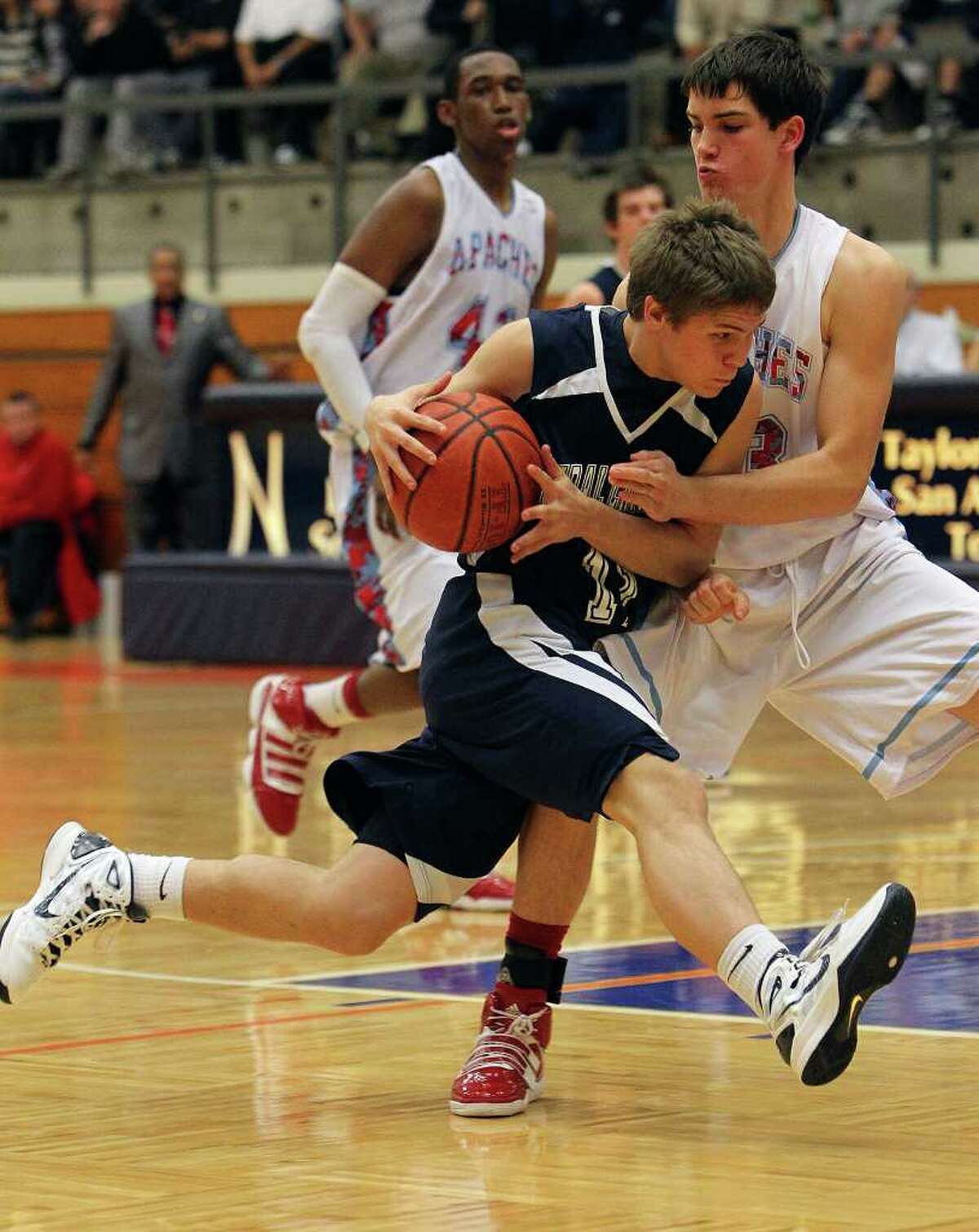 Central Catholic's Collin Fabac (11) drives to basket against Antonian's Mike Boyd (23) in boys basketball at Taylor Fieldhouse on Wednesday, Jan. 12, 2011. Central Catholic defeated Antonian 64-54. Kin Man Hui/kmhui@express-news.net