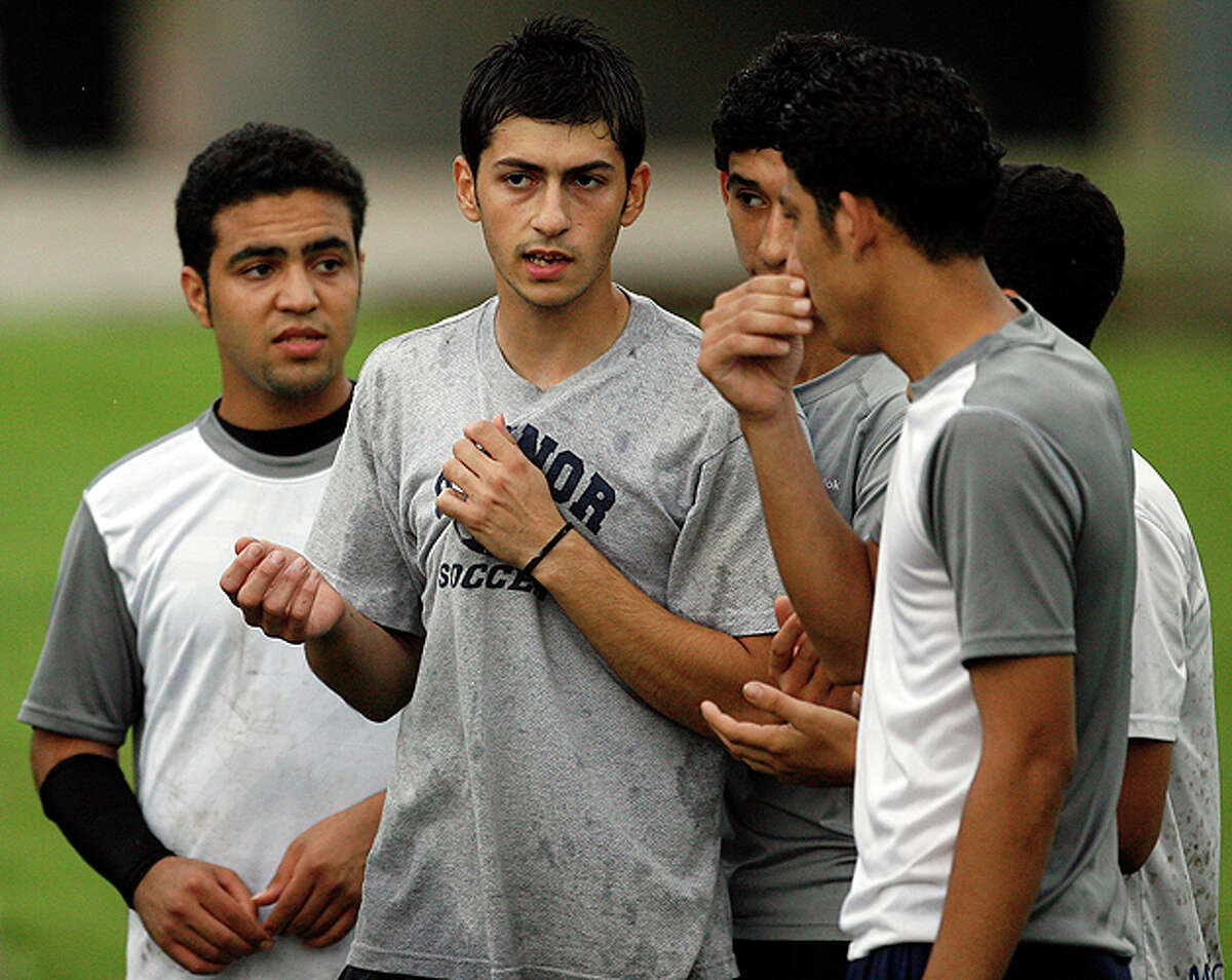 Ibrahim Ibrahim (center) discusses strategies with his teammates before a game against the young men of Team Somal.