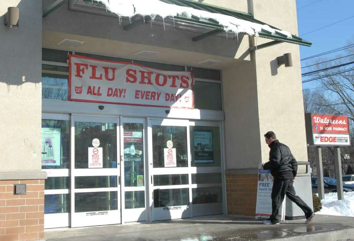 Walgreens Pharamcy in Old Greenwich has a flu shots sign hung above the entrance to their store off East Putnam Avenue, Friday afternoon, Jan. 14, 2011.