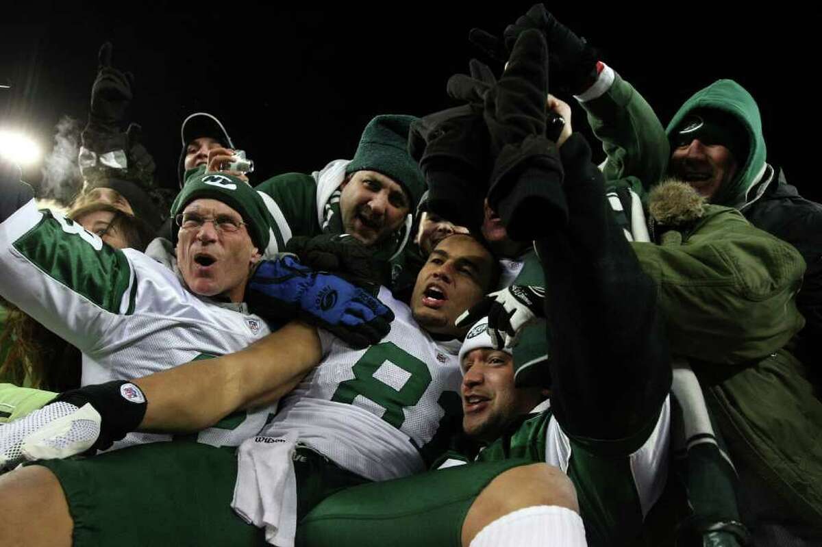 FOXBORO, MA - JANUARY 16: Dustin Keller #81 of the New York Jets celebrates with fans after the Jets defeated the Patriots 28 to 21 in their 2011 AFC divisional playoff game at Gillette Stadium on January 16, 2011 in Foxboro, Massachusetts. (Photo by Al Bello/Getty Images) *** Local Caption *** Dustin Keller