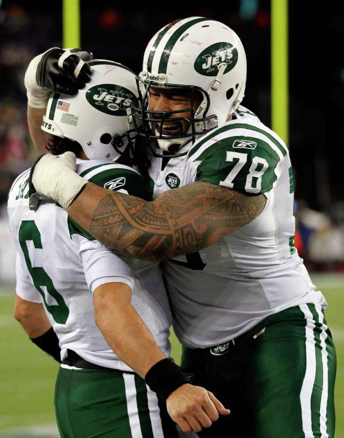 FOXBORO, MA - JANUARY 16: Mark Sanchez #6 of the New York Jets and Wayne Hunter #78 celebrate on their way to defeating the New England Patriots 28 to 21 victory over the New England Patriots during their 2011 AFC divisional playoff game at Gillette Stadium on January 16, 2011 in Foxboro, Massachusetts. (Photo by Jim Rogash/Getty Images) *** Local Caption *** Mark Sanchez;Wayne Hunter