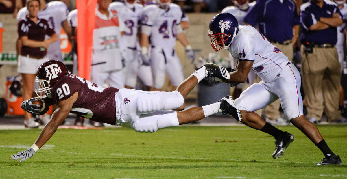 Texas A&M's Bradley Stephens, seen here diving past Stephen F. Austin's Delano King for a first down during a Sept. 4 game, opted to forego his last season of eligibility to graduate and enter the workforce. Stephens rushed for 328 yards the last three seasons.