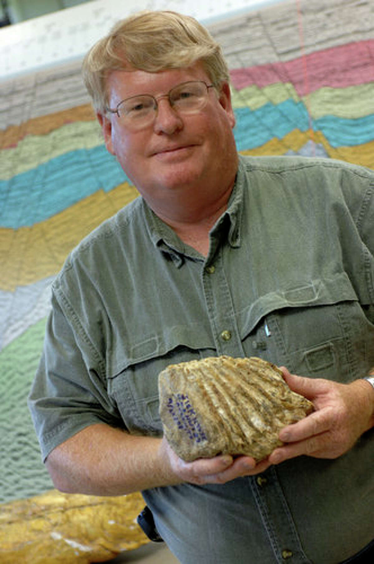 Jim Westgate with mammoth tooth found in Caplen, Texas at the home of Lamar University faculty colleague Dorothy Sisk. photo provided by Lamar University