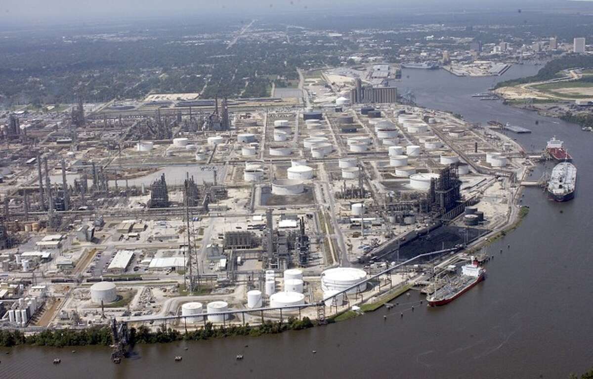 FILE - The ExxonMobil Refinery on the Neches River, part of the Sabine-Neches Waterway with the city and Port of Beaumont in the background. Dave Ryan/