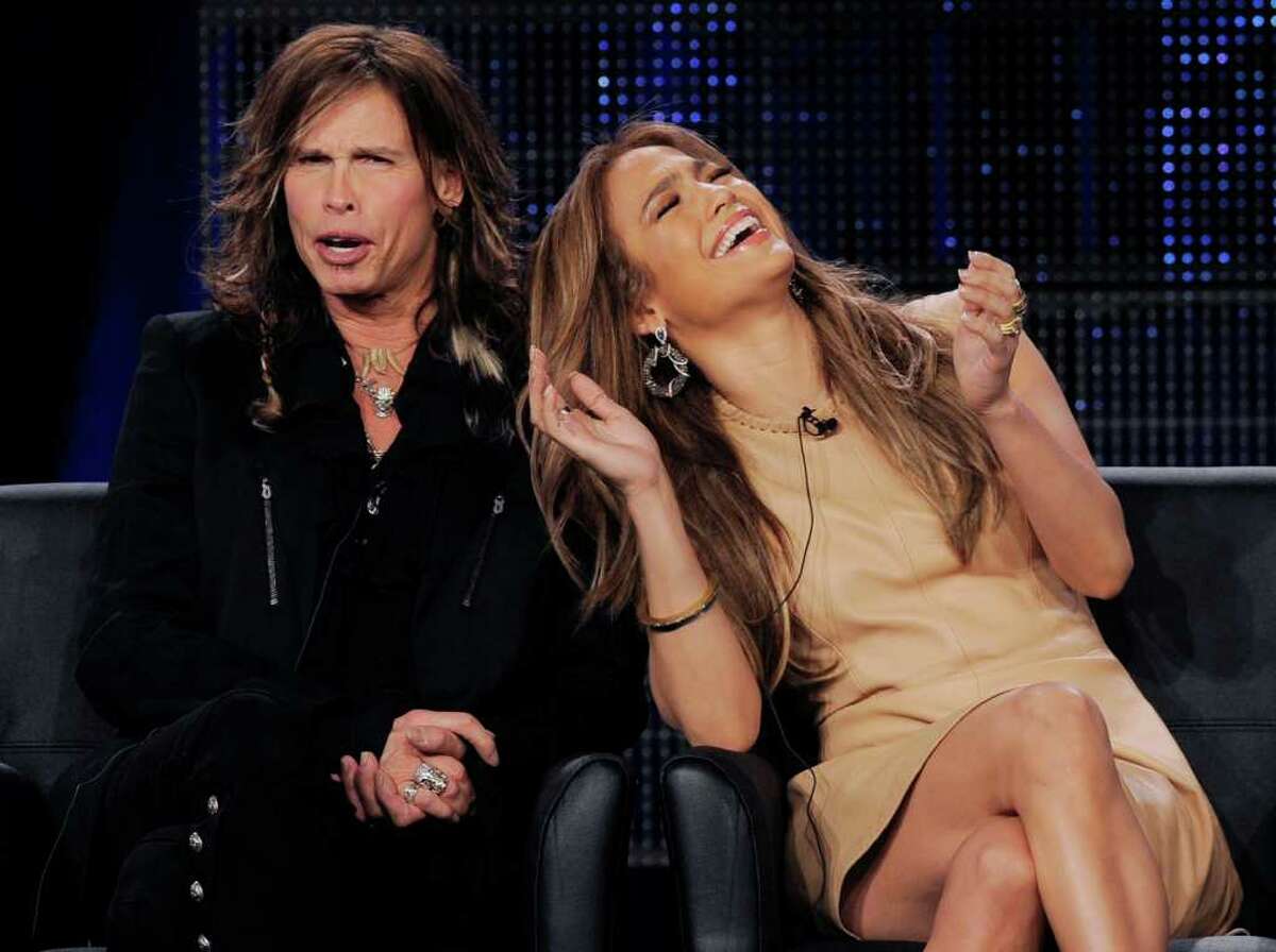 Steven Tyler, left, and Jennifer Lopez, new judges on the FOX series "American Idol," react during a panel discussion on the show at the FOX Broadcasting Company Television Critics Association winter press tour in Pasadena, Calif., Tuesday, Jan. 11, 2011. (AP Photo/Chris Pizzello)