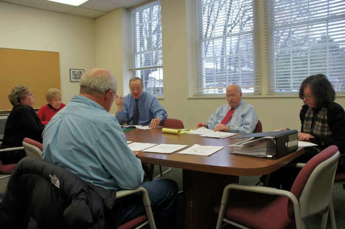 Town pension board members meet on Wednesday, Jan. 19, 2011 at Town Hall to consider a request by First Selectman Gordon Joseloff to join a town pension plan. Wearing a red tie, Joseloff sits next to Helen Garten, a pension board member who also chairs the town's Board of Finance.