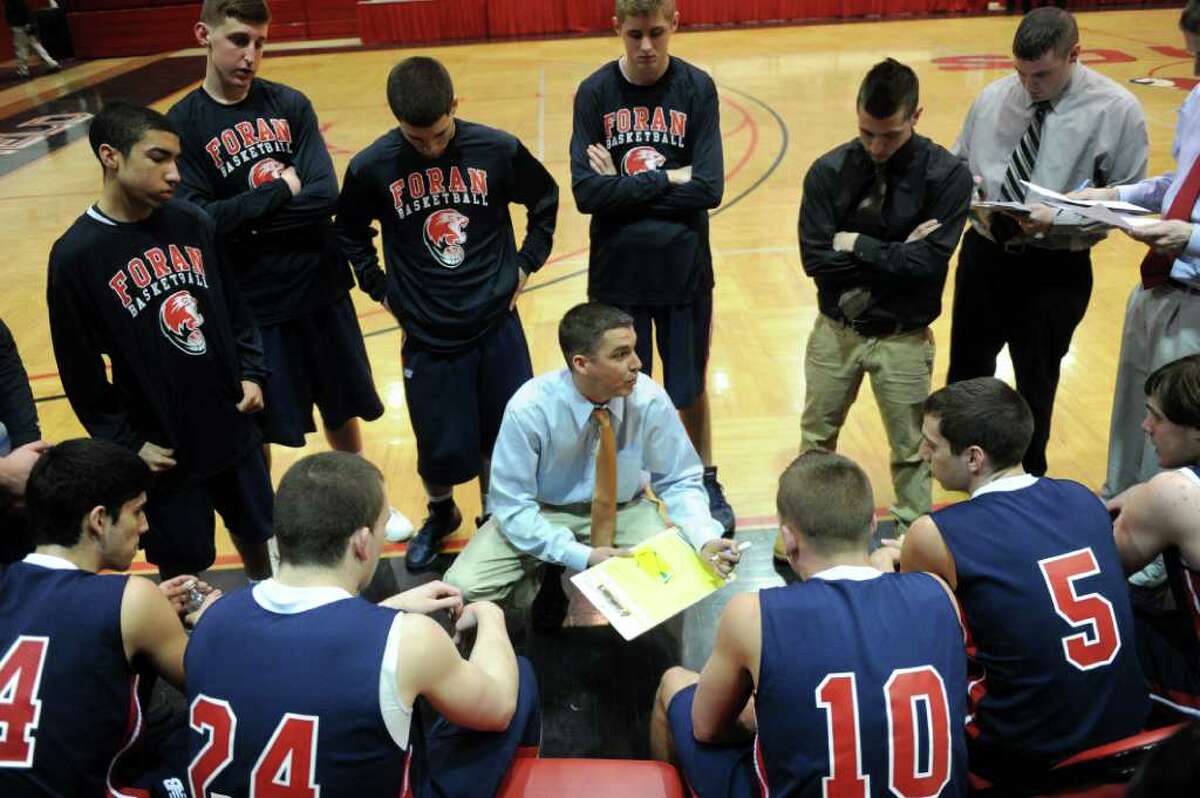 Foran's coach Tim Swaller talks to his team between quarters of Wednesday's game against Fairfield Prep at Fairfield University on January 19, 2011.
