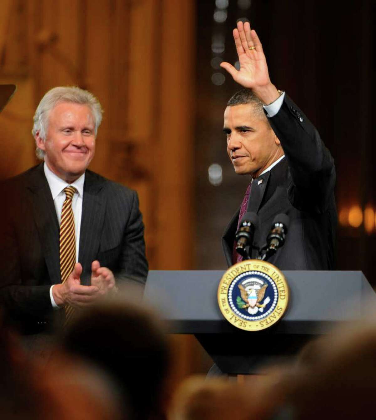 President Barack Obama waves to the gathering of workers and dignitaries as GE CEO Jeffrey Immelt looks on at the GE plant in Schenectady January 21, 2011. (Skip Dickstein / Times Union)
