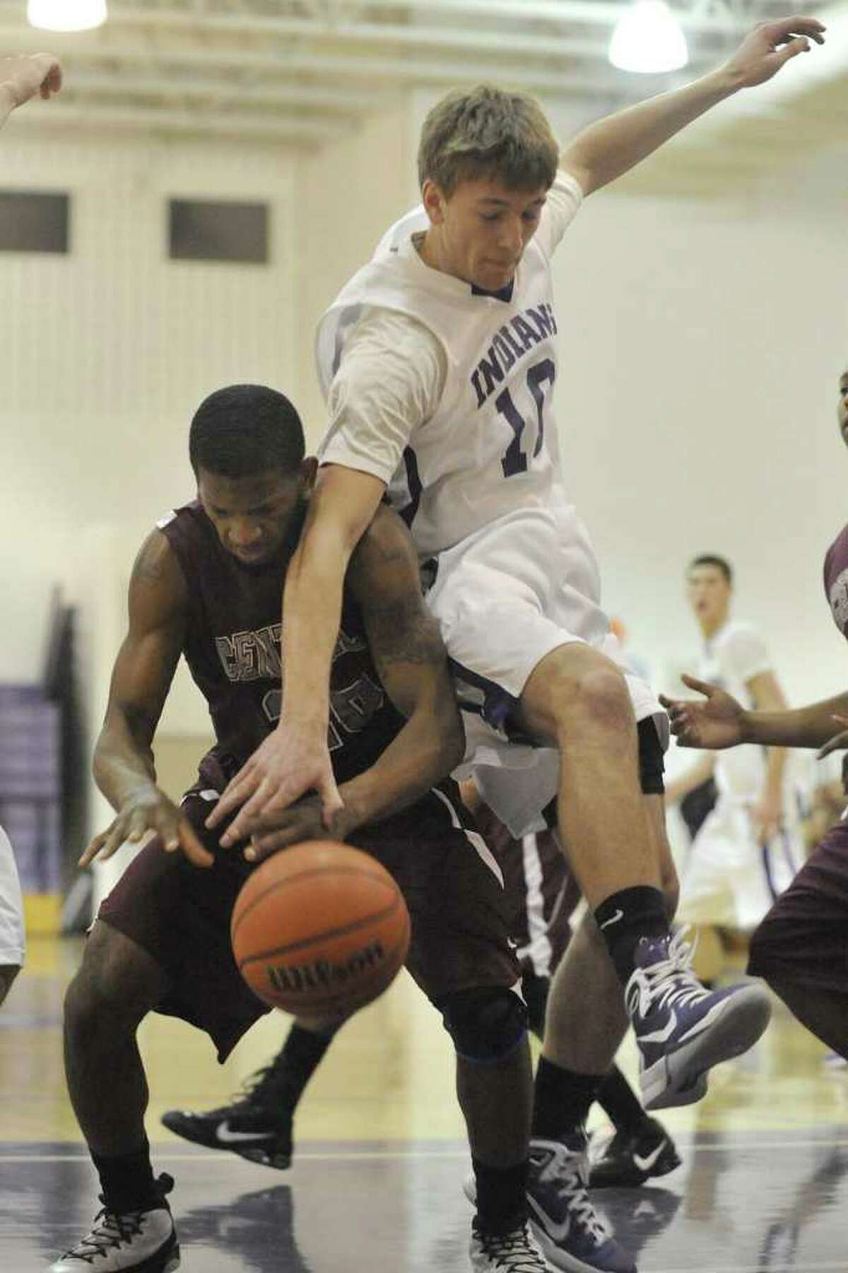 PN-G's Travis Miller, top, battles for a rebound against Central's Kristain Smith, in the first hafl of their District 20-4A game at Port Neches-Groves High School on Friday, January 21, 2011. Valentino Mauricio/The Enterprise