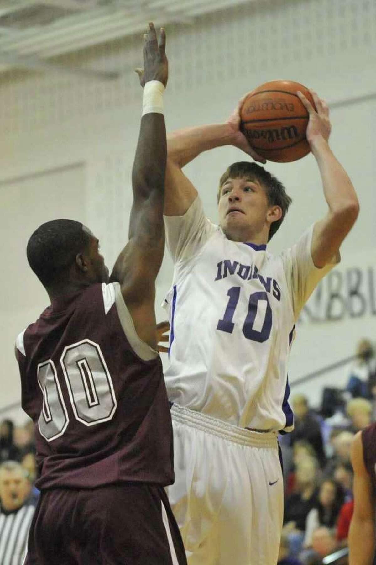 PN-G's Travis Miller shoots against Central's JaKeal Lockett in the first hafl of their District 20-4A game at Port Neches-Groves High School on Friday, January 21, 2011. Valentino Mauricio/The Enterprise