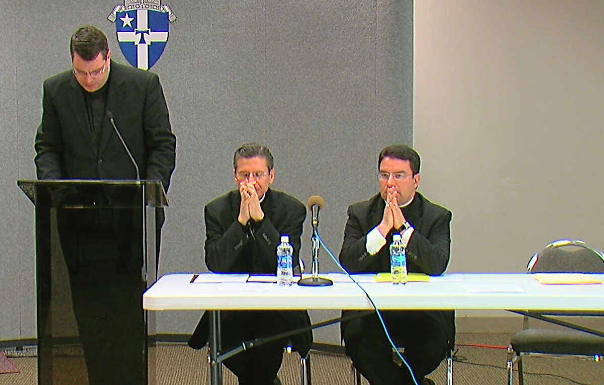 Father Martin Leopold (left), head administrator of the Archdiocese of San Antonio, says a religious order misled the archdiocese about Father John M. Fiala. Seated are Archbishop Gustavo Garcia-Siller (center) and Auxiliary Bishop Oscar Cantu.