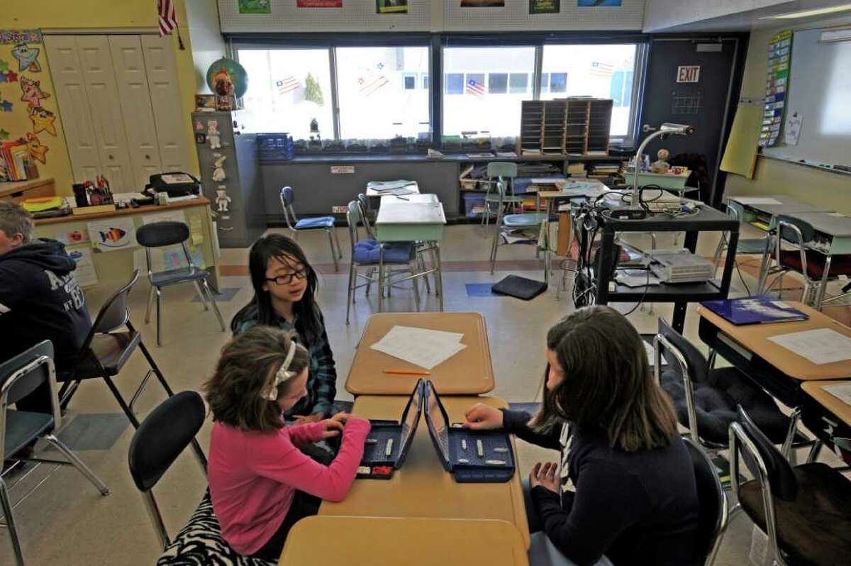 From left, McKayla Caswell, Mimi Nguyen and Kyle Calacone play Battleship at the Latham Ridge Elementary School in Latham while on class recess January 24, 2011, on a day when it was too cold to go outside. (Skip Dickstein / Times Union)
