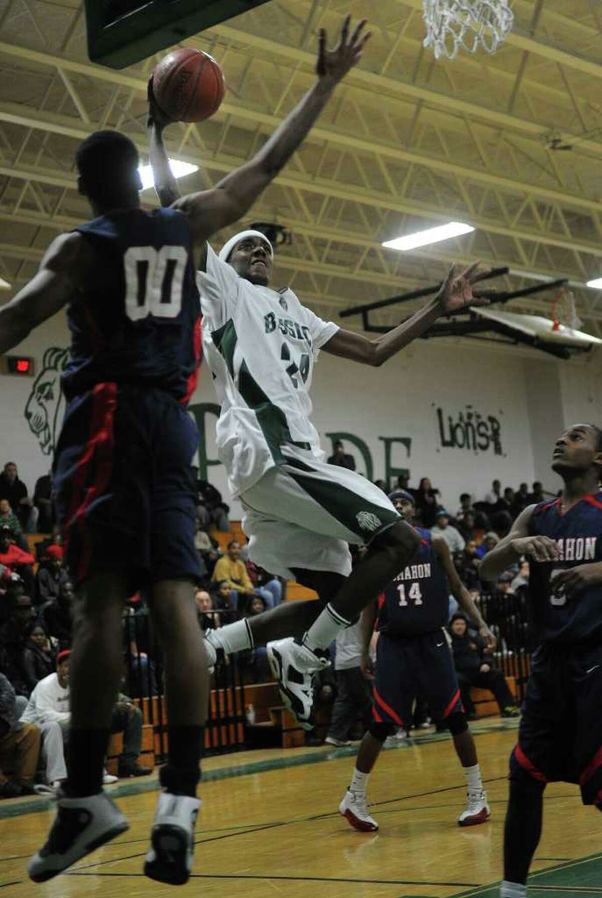 Bassick's Jamill Powell soars in for a basket against Brien McMahon defender Takari Smalls during their FCIAC matchup at Bassick High School in Bridgeport on Monday, January 24, 2011.