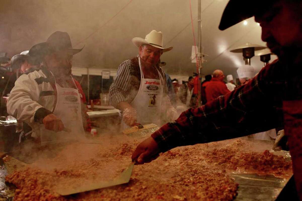 metro - Pasqual Valadez Jr., from lft, Gilbert Peralez and Pete Garibay, all volunteers from San Antonio Water System, cook chorizo with eggs for tacos during the Cowboy Breakfast at Cowboys Dance Hall on Friday, January 28, 2011. LISA KRANTZ/lkrantz@express-news.net