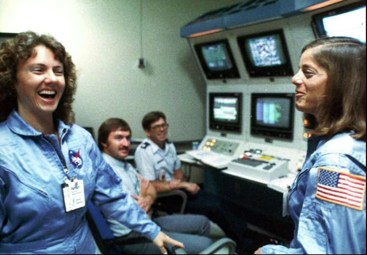 In this 1986 file photo, Christa McAuliffe, left, and Barbara Morgan, right, laugh during training. (AP Photo/NASA, File)