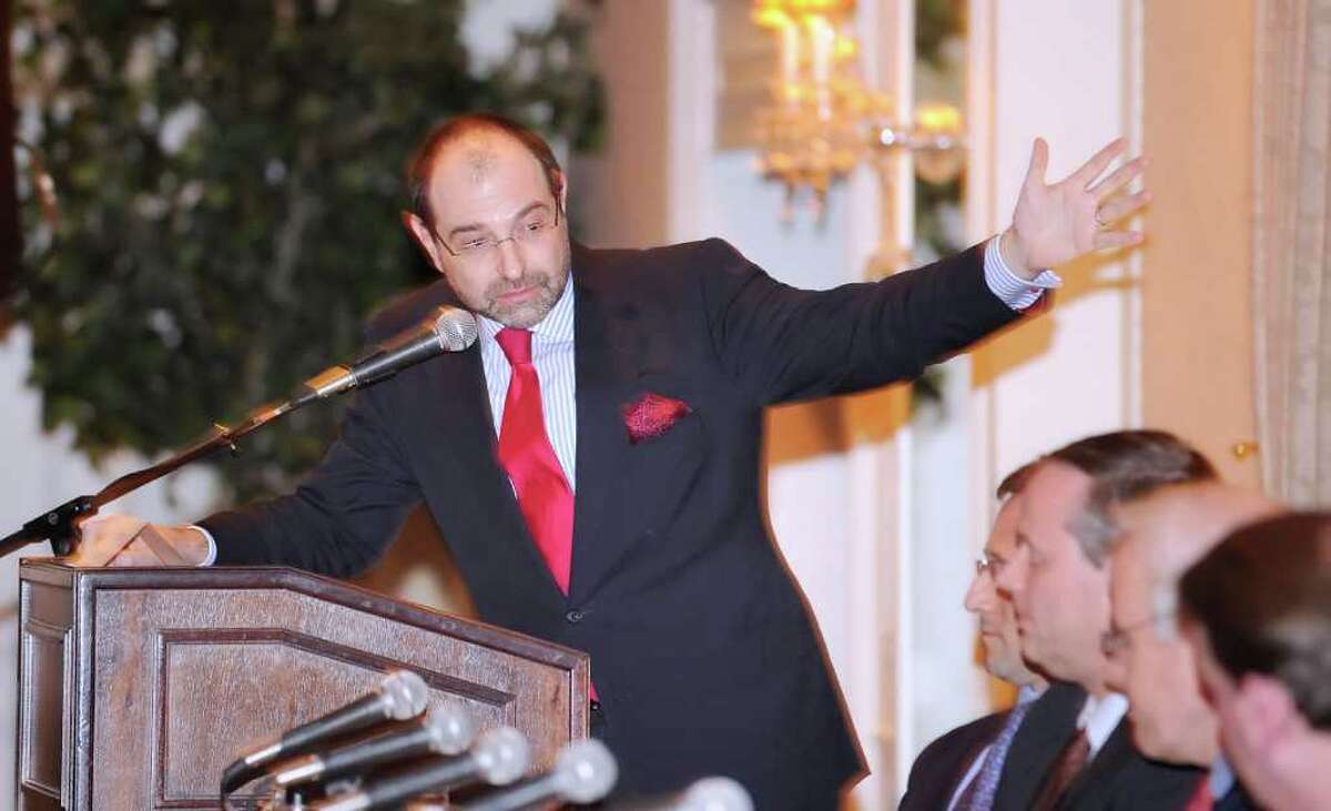 Pimm Fox, a television anchor and radio host for Bloomberg Business and Financial News, gestures while making a point to the panel during The Ninth Annual Forecast Dinner of the Stamford CFA Society at the Greenwich Country Club, Thursday night, Jan. 27, 2011.