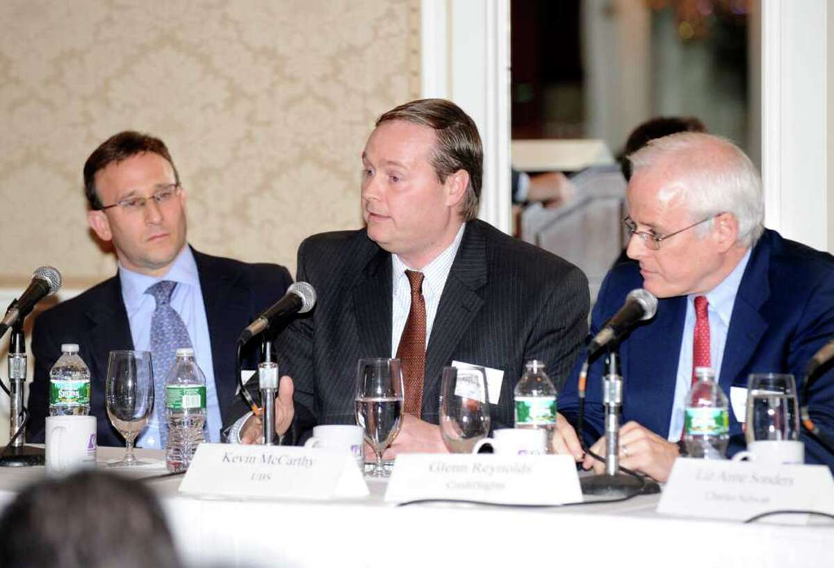 At center, Kevin McCarthy, a senior credit strategist for UBS, makes a point during The Ninth Annual Forecast Dinner of the Stamford CFA Society at the Greenwich Country Club, Thursday night, Jan. 27, 2011. At left is Russ Koesterich, a global chief of investment strategist for iShares and at right is Glenn Reynolds, CEO of CreditSights.