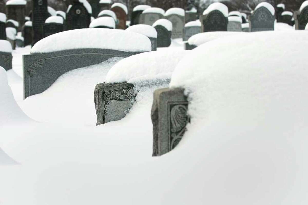 Gravestones in a local cemetery are deep in the snow after several snowstorms hit the area recently.
