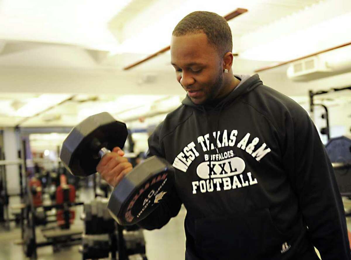 Michael Norris / Michael Norris Photography..Derrick Hall, running back with West Texas A&M University, works out in the weight room Tuesday, January 25, 2011.