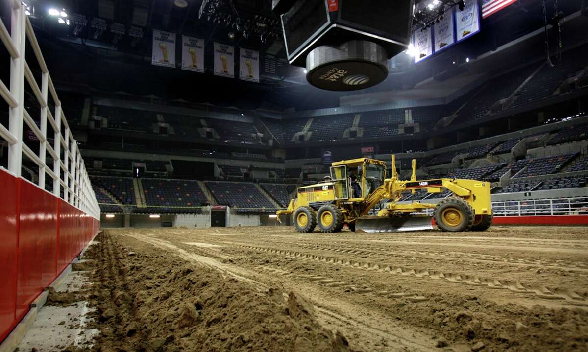 Workers dump and spread 2,160 tons of dirt in the ATT Center in preparation for the 2011 San Antonio Stock Show and Rodeo. Bob Owen/rowen@express-news.net