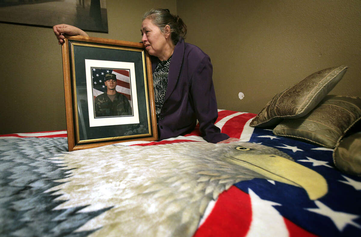 Maria Soltero grieves for her som Omar Soltero, an Army specialist who died in Afghanistan. She bought the patriotic bedspread when he first joined the service.
