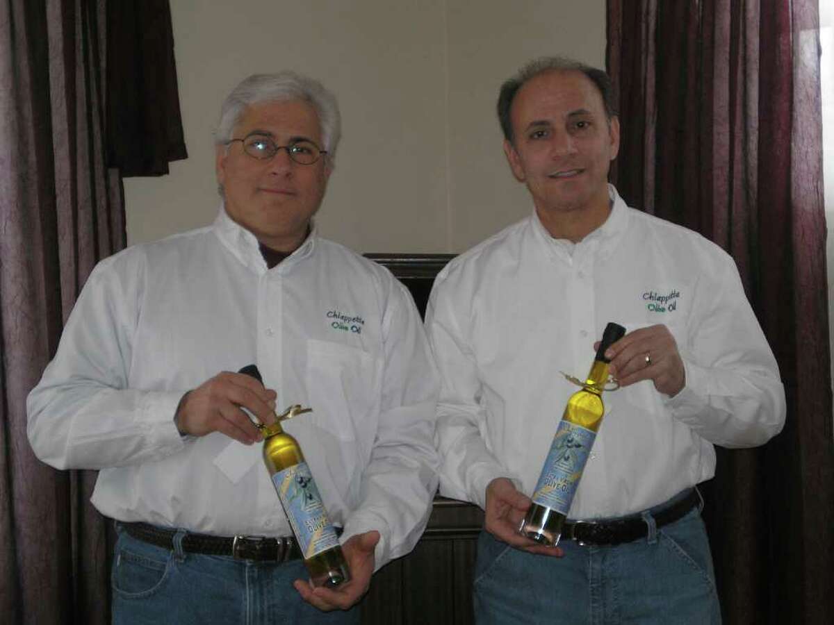 Pat Chiappetta, left, and Frank Chiapetta display samples of their family's olive oil.