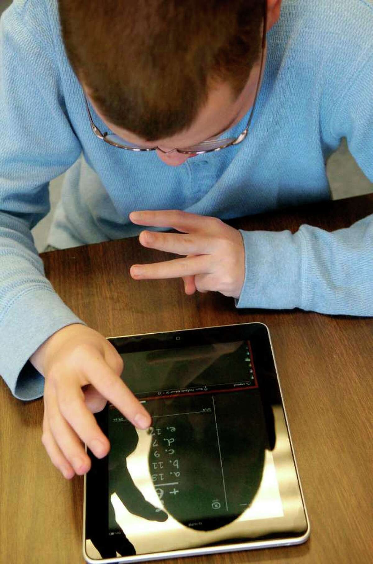 Mickey Teubert, a students in Stamford (Conn.) High School's autism spectrum disorder classroom, uses a iPad after completing his math lesson on Thursday February 3, 2011.