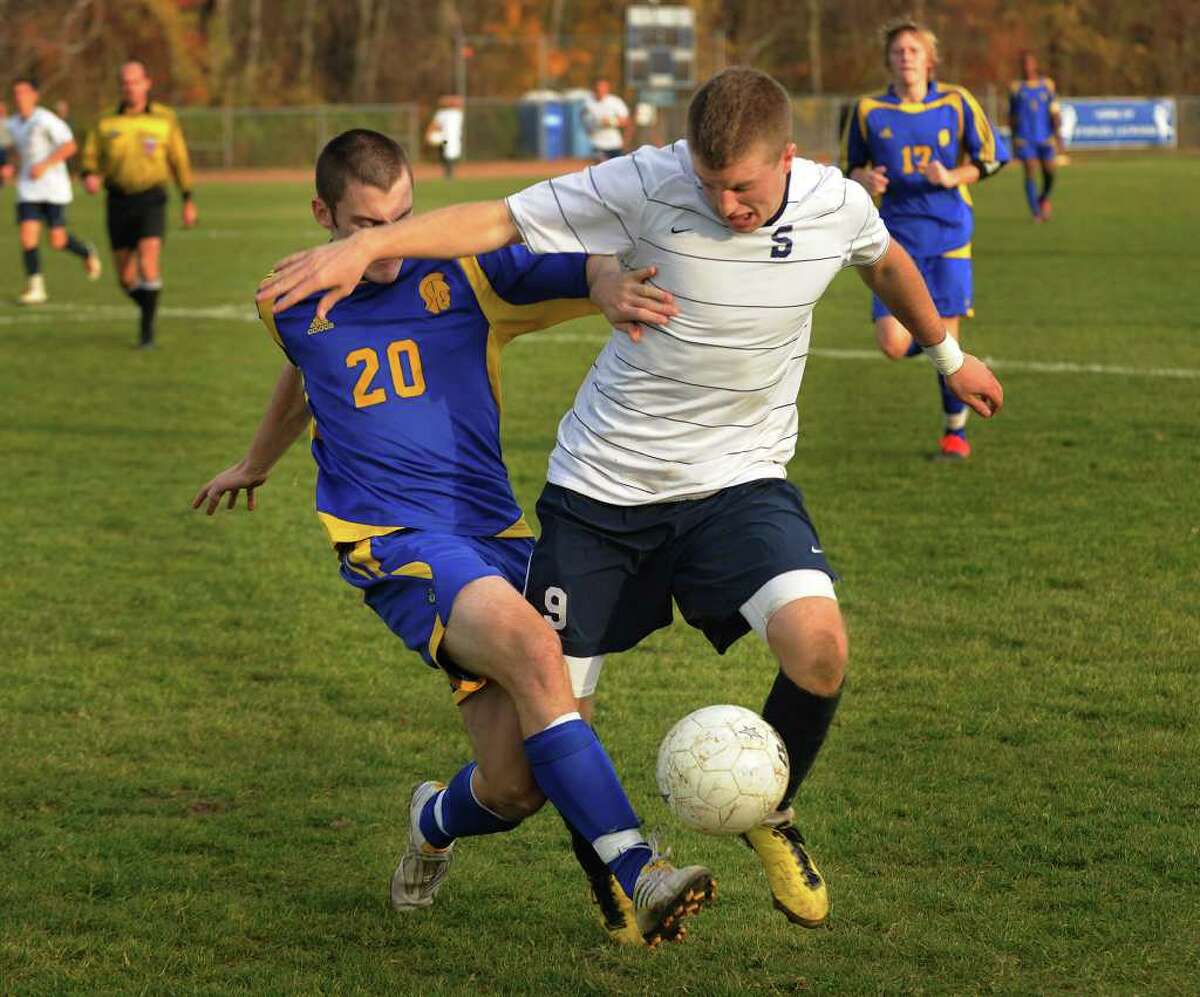 Simbury's Andrew Yanik, left, battles for the ball with Staples' Brendan Lesch during the Wreckers' 1-0 victory in the Class LL quarterfinals at Staples High School on Monday, November 15, 2010.