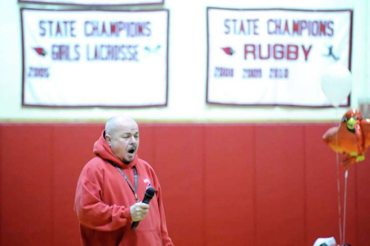 Dick Leonard, an instructor at Greenwich High School, sings the National Anthem prior to the start of the girls high school basketball game between Greenwich High School and Bassick High School at Greenwich High School, Thursday night, Feb. 3, 2011.