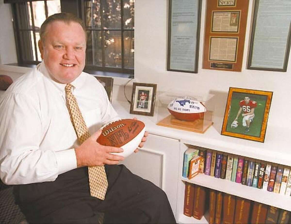 Robert Burton in his Greenwich office in 1997. Burton is demanding the return of $3 million in donations to the University of Connecticut and the removal of his name from a campus building because he wasn't consulted when the school hired Paul Pasqualoni as its new football coach.