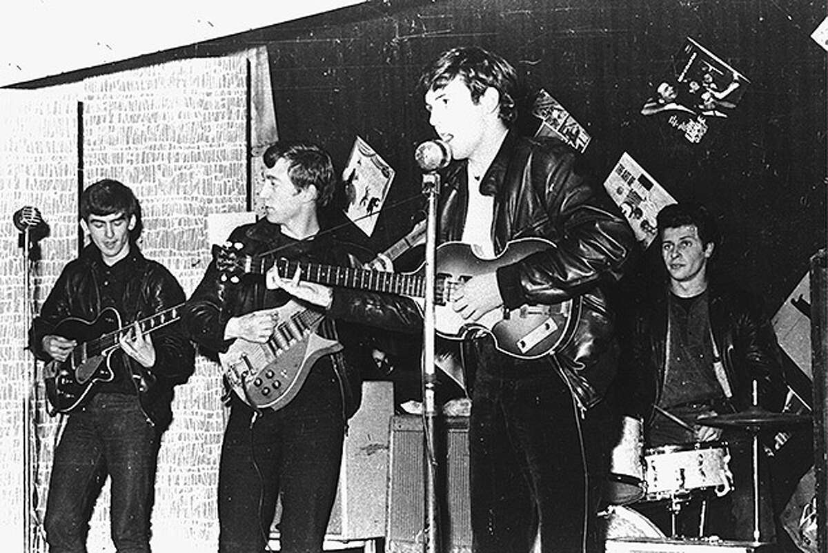 British rock group The Beatles perform in a club prior to signing their first recording contract, Liverpool, England, 1962. L-R: George Harrison, John Lennon, Paul McCartney, and original drummer Pete Best.