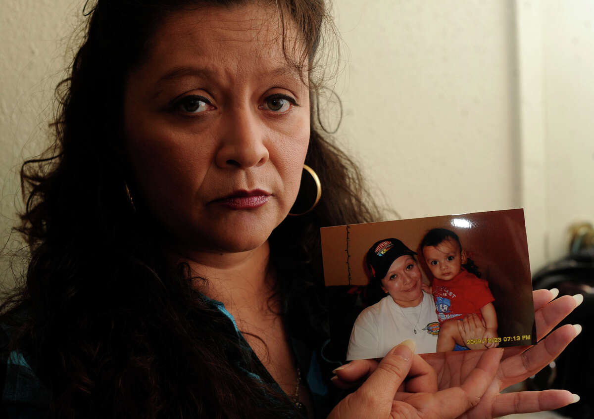 Virginia Ortiz holds a photo of herself with grandson Pedro Antonio Salgado Jr., who died after being left alone in a bathtub last year.