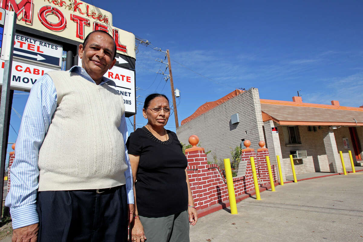 Jagdish Patel stands with his wife, Dhani, in front of the Everkleen Motel, which he owns, on Roosevelt Avenue. The Everkleen Motel is one of three along Roosevelt Avenue named in a city lawsuit alleging they tolerate and enable prostitution.
