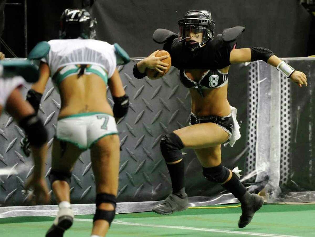 LAS VEGAS, NV - FEBRUARY 06: Quarterback Ashley Salerno #8 of the Los Angeles Temptation runs for yardage against the Philadelphia Passion during the Lingerie Football League's Lingerie Bowl VIII at the Thomas & Mack Center February 6, 2011 in Las Vegas, Nevada. Los Angeles won 26-25. (Photo by Ethan Miller/Getty Images)
