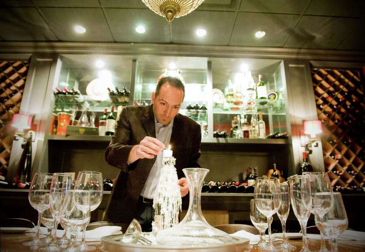 Enzo Bruno lights a candle in the wine room of his Madonia Restaurant and Bar on Long Ridge Road in Stamford, Conn., Jan. 20, 2011. The wine room is private, separated from the rest of the restaurant by glass. It seats up to 10 people and though reservations are not necessary, they are advised.
