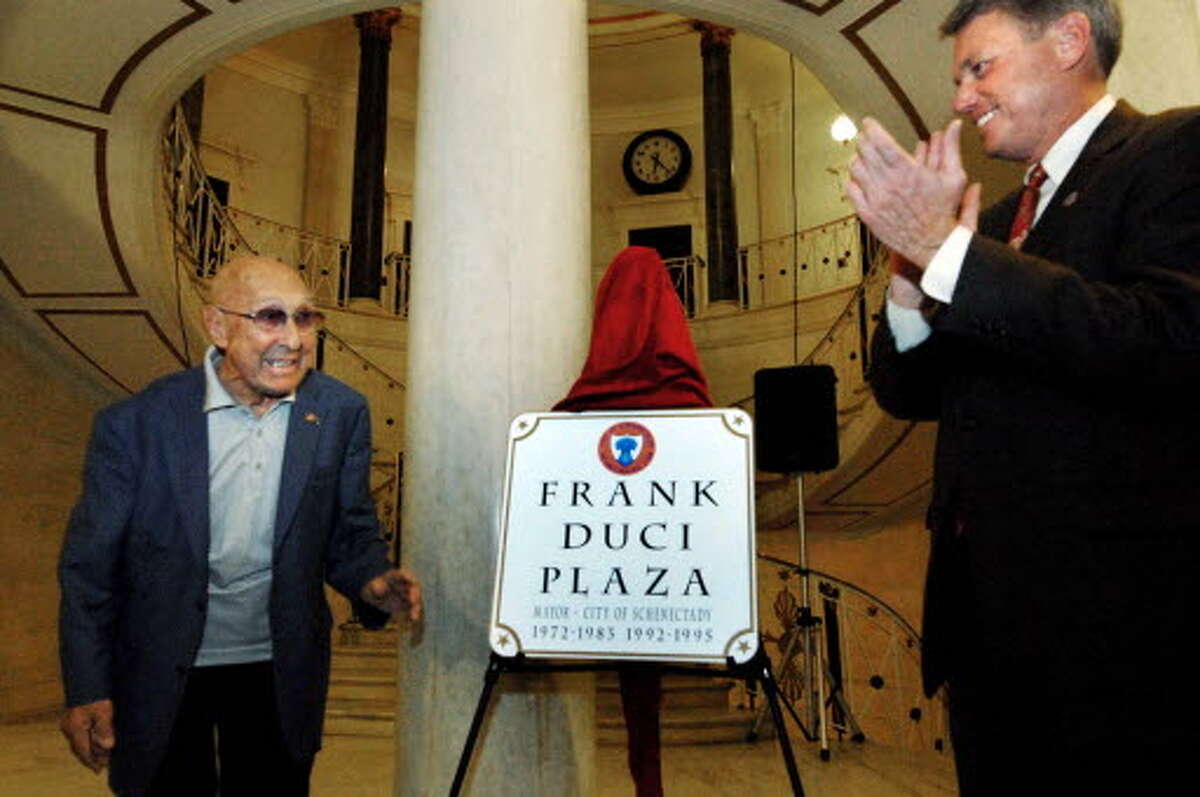 Former Schenectady Mayor Frank Duci , left, who served for a total of 16 years, is honored by the city of Schenectady and current Mayor Brian Stratton on Oct. 16, 2009. A portion of Avenue A , where he lives, was renamed Frank Duci Plaza during the ceremony in the rotunda of City Hall. (Michael P. Farrell / Times Union archive).