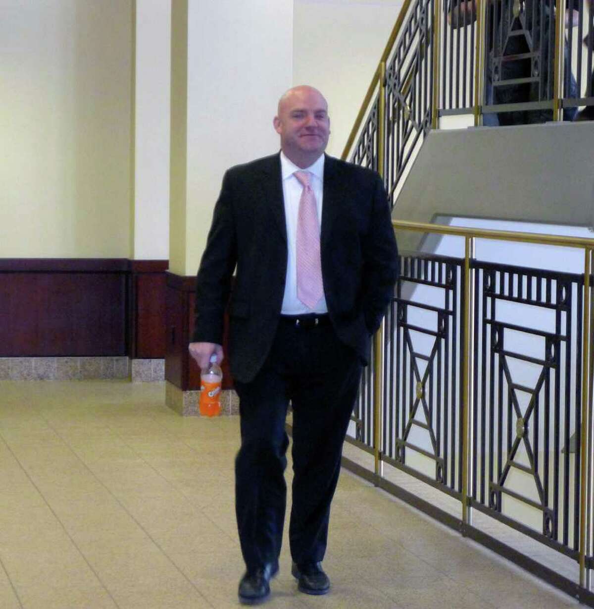 Albany Police Officer Robert E. Schunk makes his way in to Albany County Court Wednesday Feb. 9, 2011. Schunk, 39, a 12-year veteran of the Albany police force, is on trial for felony and misdemeanor charges .( Michael P. Farrell/Times Union )