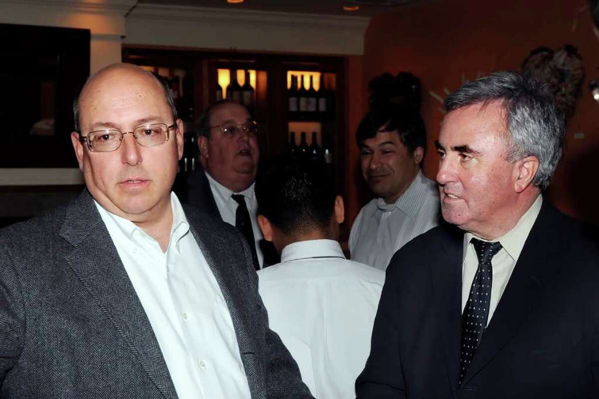 Greenwich defense attorney Philip Russell, left, speaks with lawyer and Greenwich native Mickey Sherman who will be sent to prison next month for failing to pay his taxes, at the Greenwich Tavern during a cocktail reception held for Sherman, early Thursday night, Feb. 10, 2011.