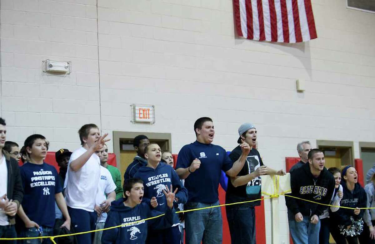 Fans cheer during a match at the FCIAC wrestling championship at New Canaan High School in New Canaan, Conn. on Saturday February 12, 2011.