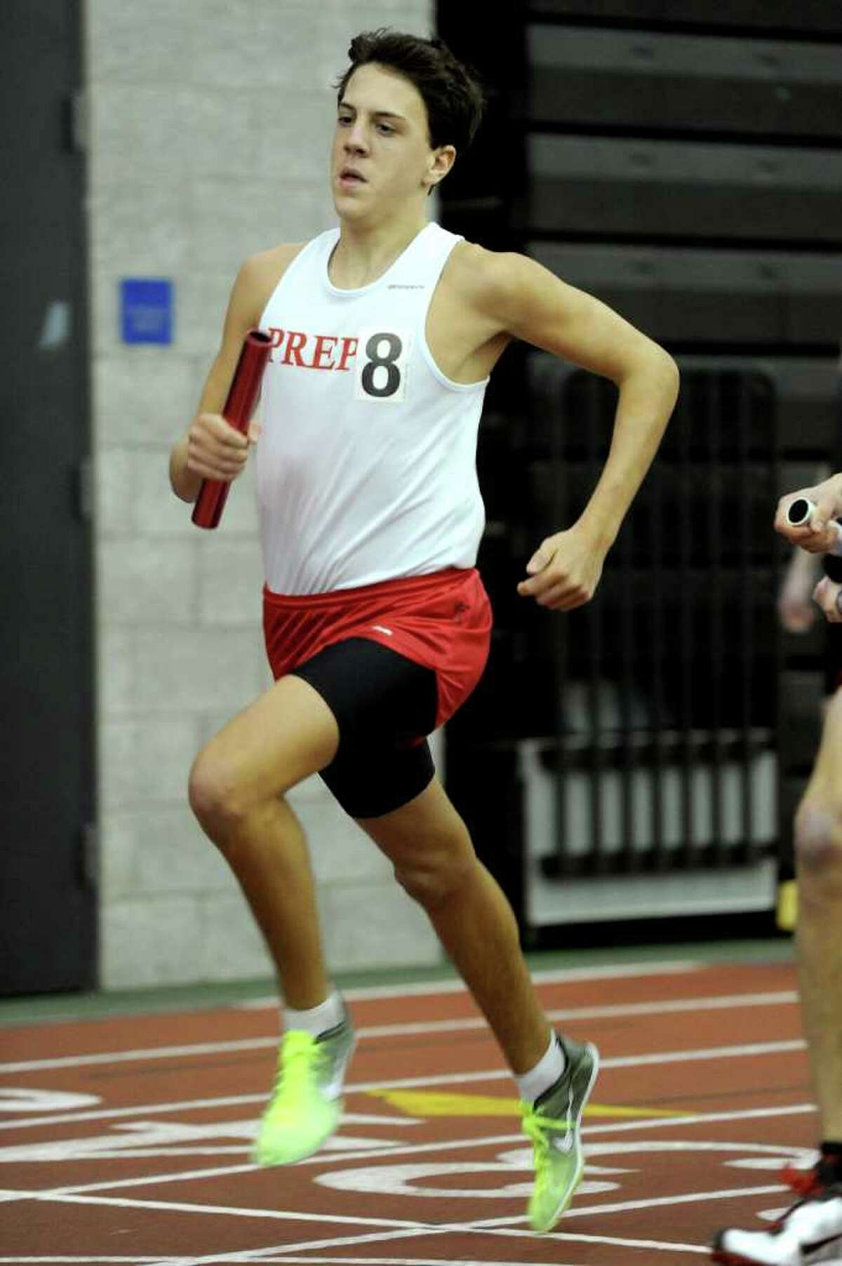 Fairfield Prep's Patrick Corona runs in the 4x800 relay during Saturday's Class LL track championship meet at the New Haven Athletic Center on February 12, 2011.