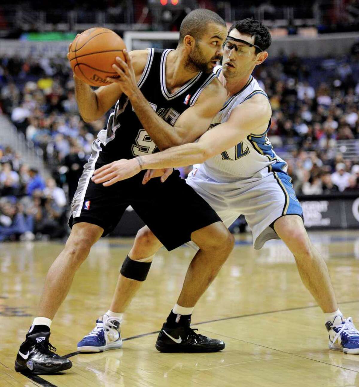 Spurs guard Tony Parker (left), shown under pressure from Washington Wizards guard Kirk Hinrich, has been in All-Star form since basketball became his “escape” from personal drama.
