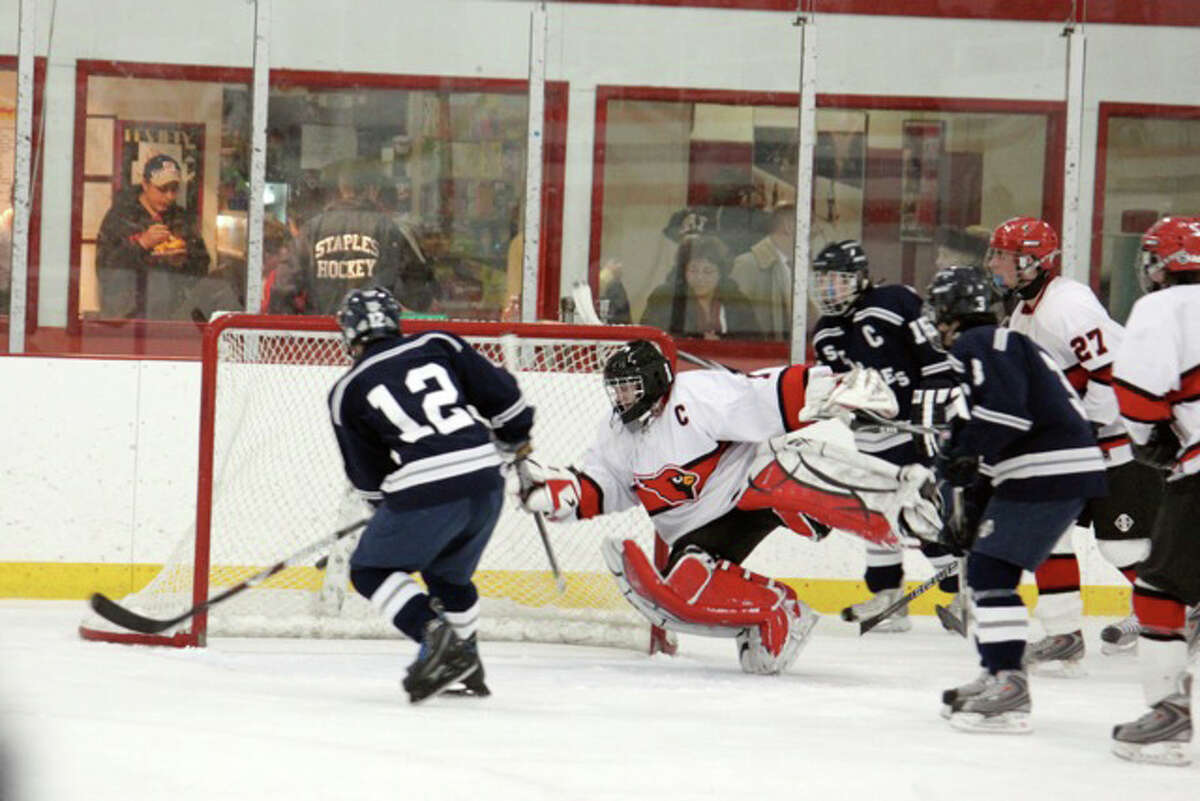 Staples junior captain Aaron Liu scores the first of his two goals Monday in a 3-2 victory at Greenwich.
