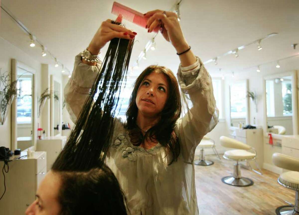 Hair Stylist Ayrica Gelinas of Woodbury gives a haircut to client Rachel Cordova of Ansonia at Greg & Tony Salon in Wesport on Tuesday, February 15, 2011. A tax on haircuts is one of the many new taxes proposed in Governor Dannel P. Malloy's state budget.