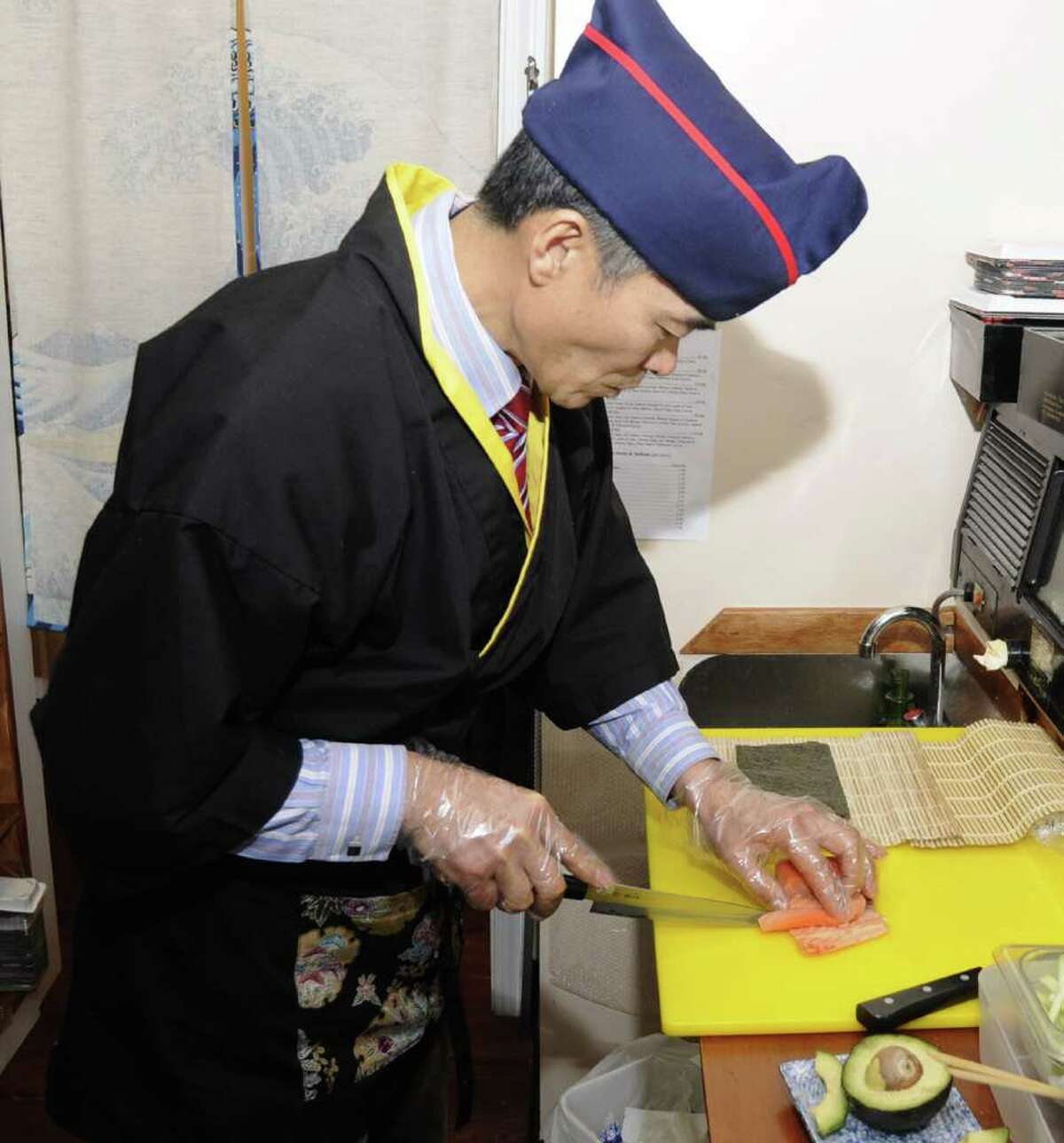 Sushi chef Jay Lim, owner of Edo II, in Danbury, prepares a Philadelphia Roll.