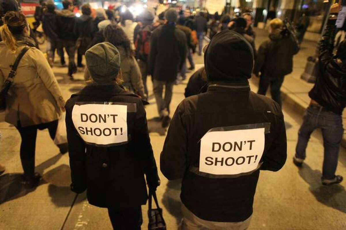 Protesters march down Fourth Avenue on Wednesday night bearing a message for local police.
