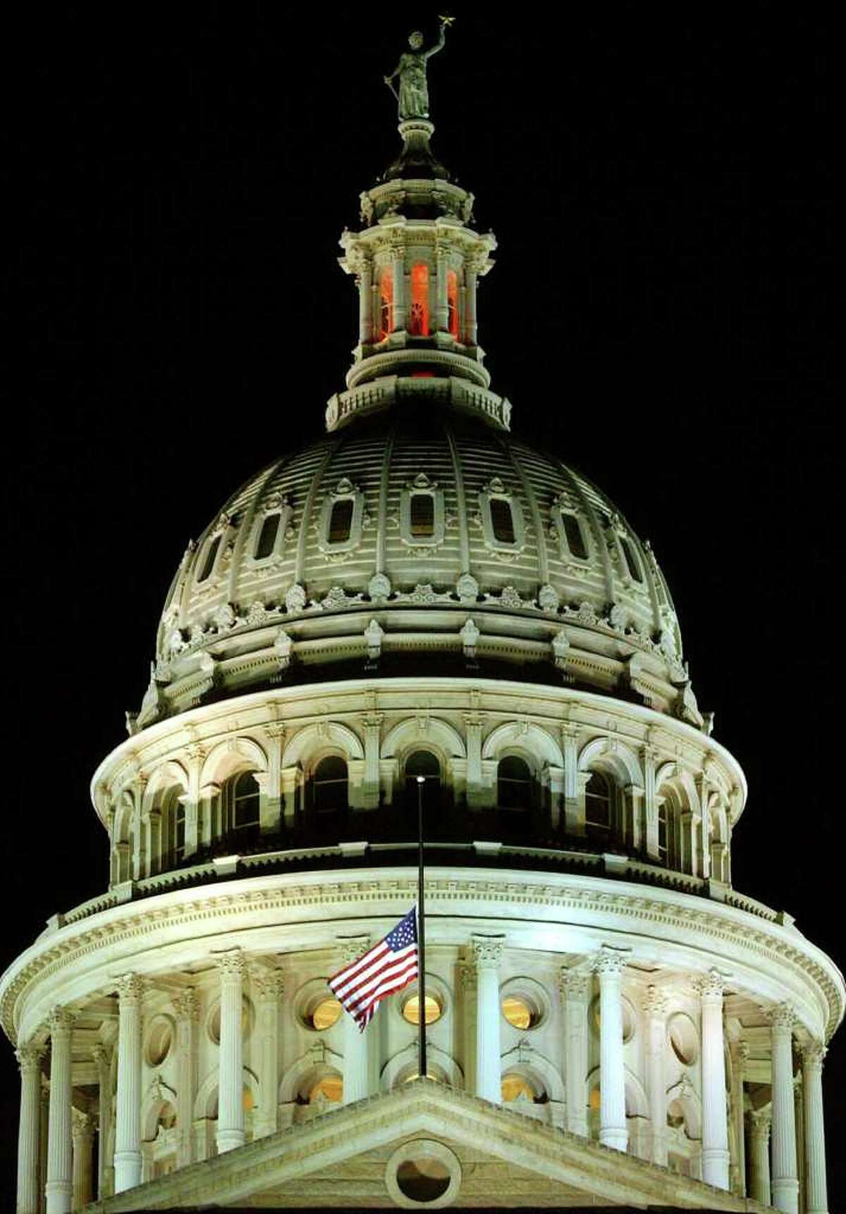 FOR METRO - The American flag, on the Texas Capitol in Austin, flies at half-staff in memorial of the seven astronauts that died aboard space shuttle Columbia Saturday Feb. 1, 2003. PHOTO BY EDWARD A. ORNELAS/STAFF